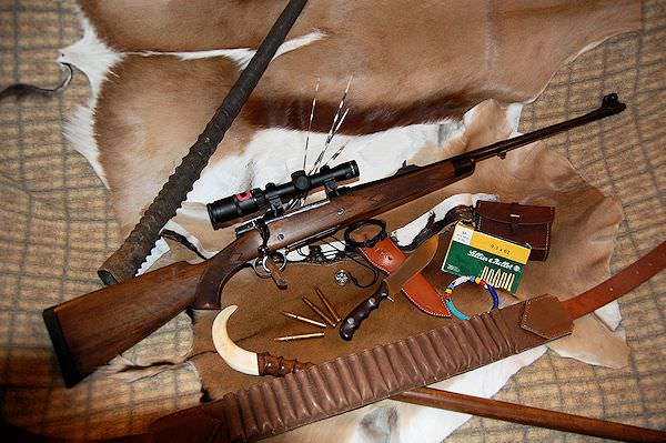 A hunter prepares to take a shot with his rifle.